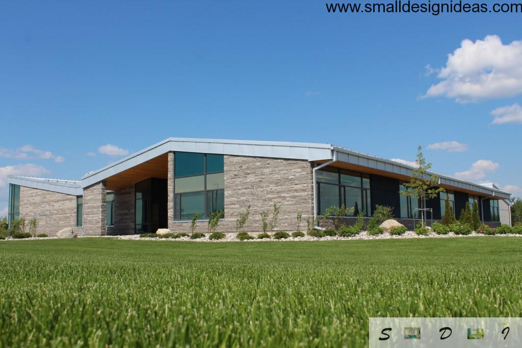 Greeen ecological brick facade of the modern house with panel windows