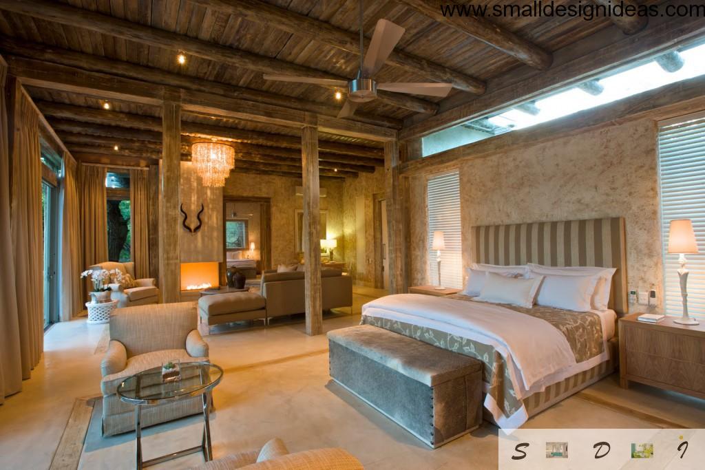 Original country-style bedroom with wooden ceiling, decorative antlers and wide bed