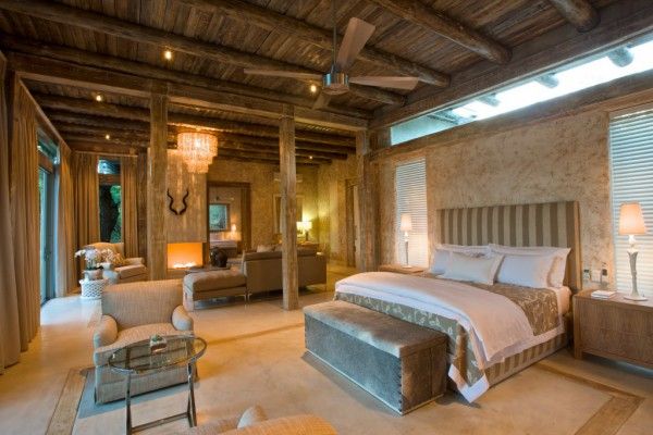 Original country-style bedroom with wooden ceiling, decorative antlers and wide bed