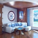 Small rest zone in the living room with porthole window, bell and picture