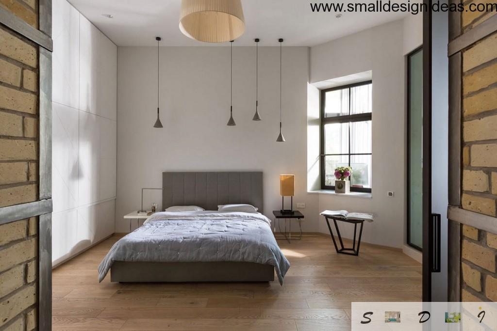 Wide window in the Loft bedroom located right next to the bed and pendant lights