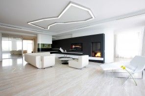 Minimalism Interior Design Style in the living room with fireplace, contrasting black wall and unusual lighting
