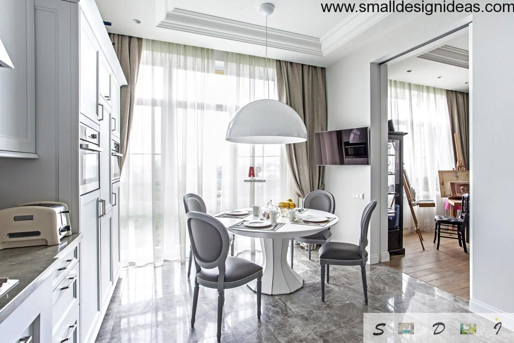 Neoclassic design style in the interior of dining room with big French windows