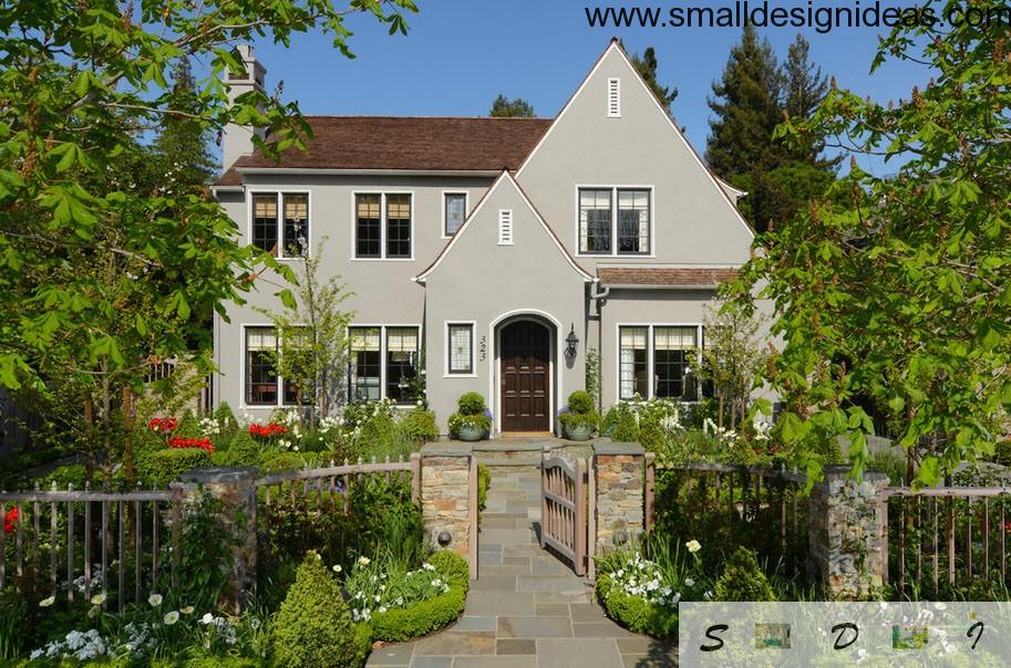 Gray trim of the house and verdure makes the English style of the house distinguishable