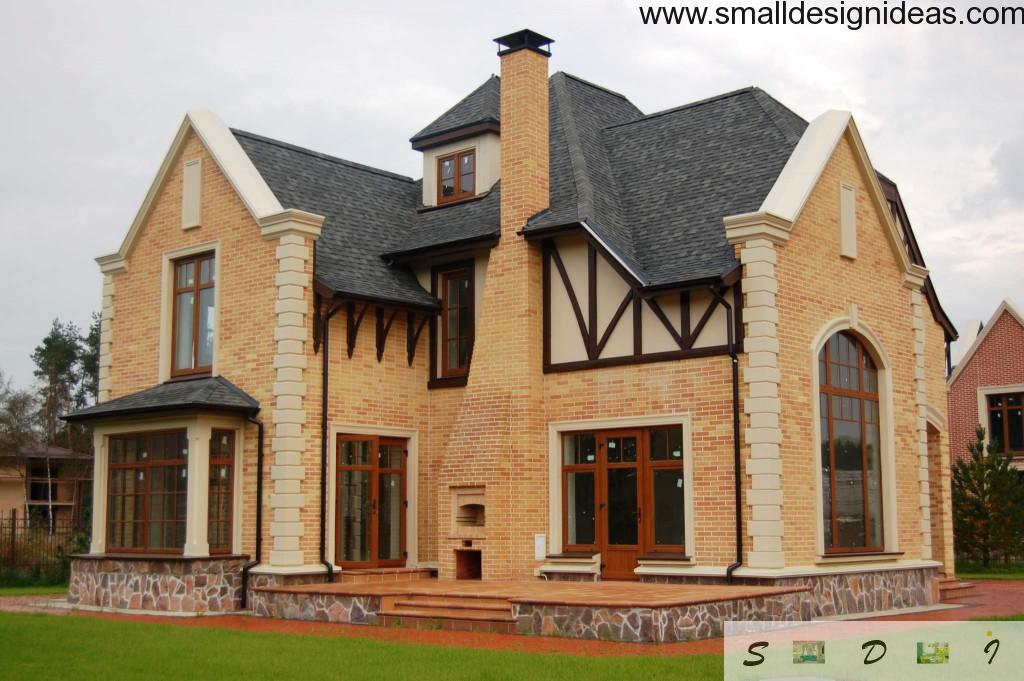 Cottage from sandy colored bricks and mahogany door and windows with an area for veranda at the entrance