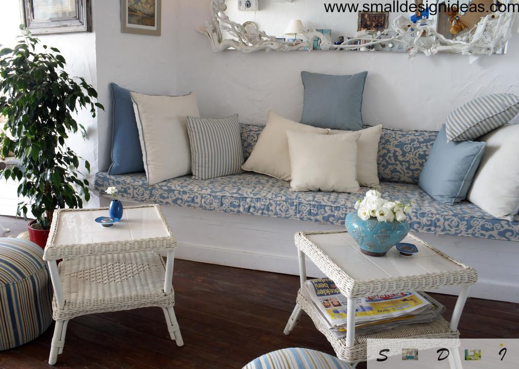 Calm and fresh rural Provence style in the interior with marine blue motifs and a lot of pillows on the couch