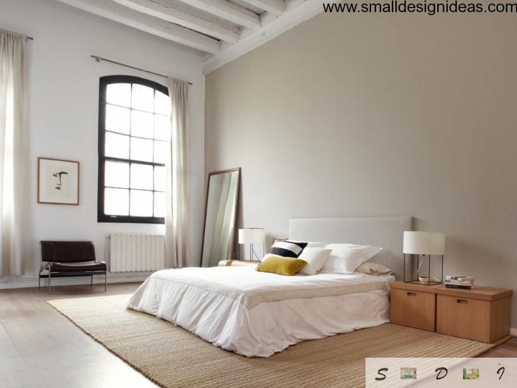 High ceiling in the Loft bedroom of New-York apartment with minimum of furniture and floor-placed mirror