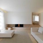 Minimalistic white creamy interior with built-in fireplace