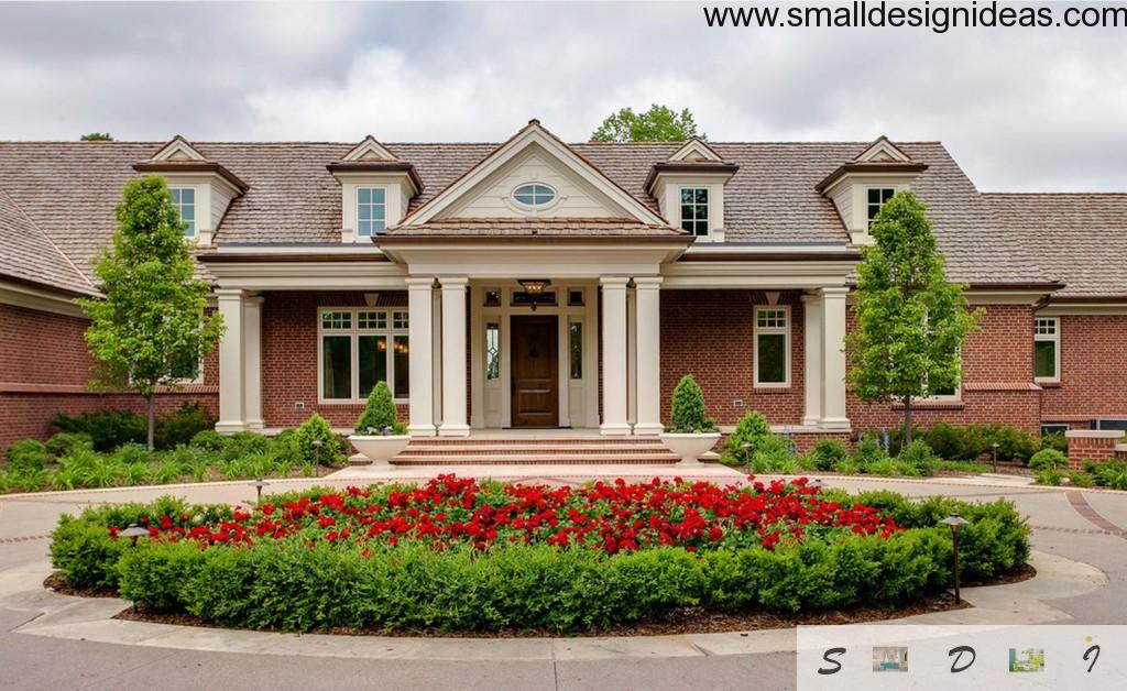 The thorough landscape design near the nice modern English style house with white columns and small windows