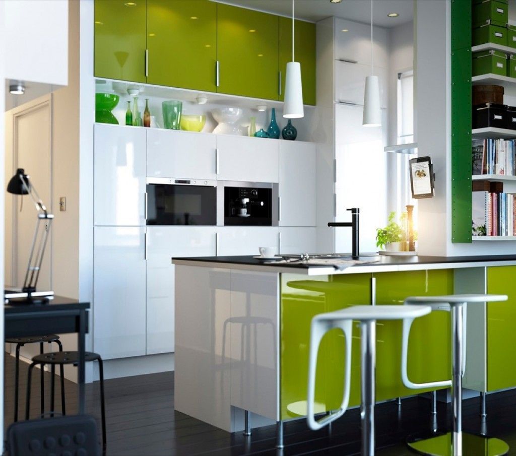 Unique island small kitchen layout with green ecological triming and white cupboard and drawers surfaces