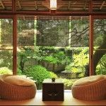 Veranda of the country house in the Japanese style with rattan puffs and low table