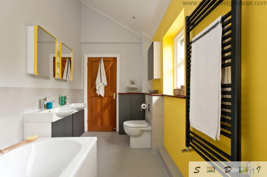 Yellow colour and mirror adds joy into the bathroom interior