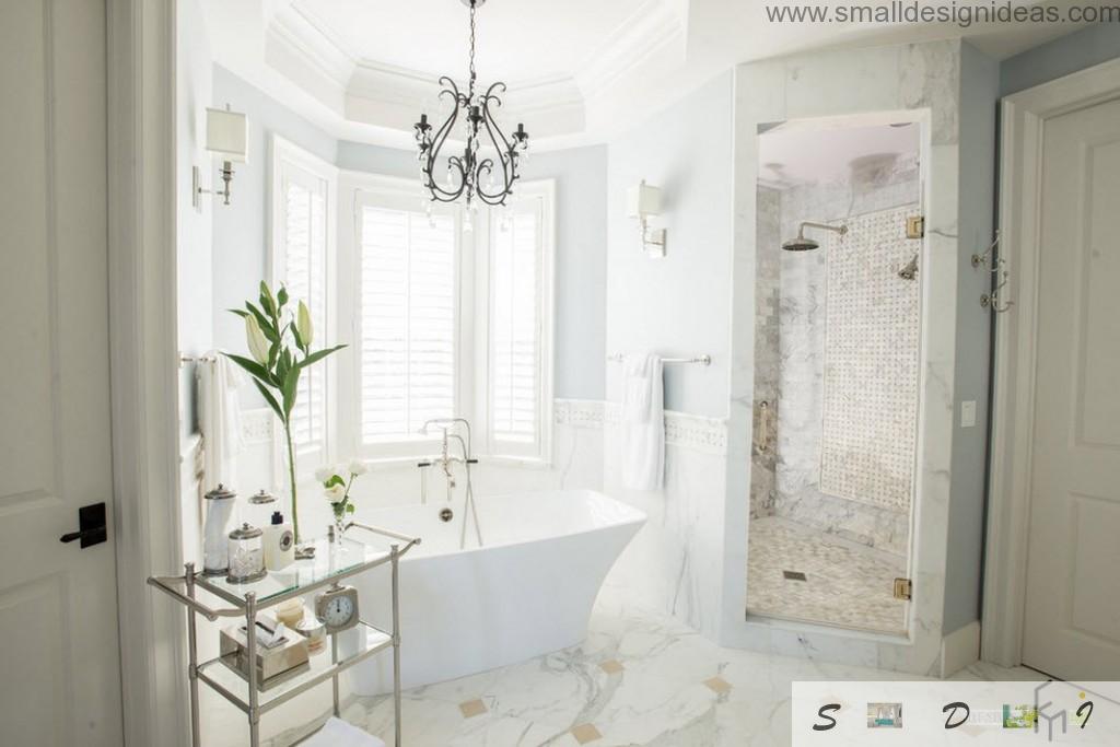 Classic European design of the bathroom with chic shower cubicle and bathroom at the bay window and marble floor