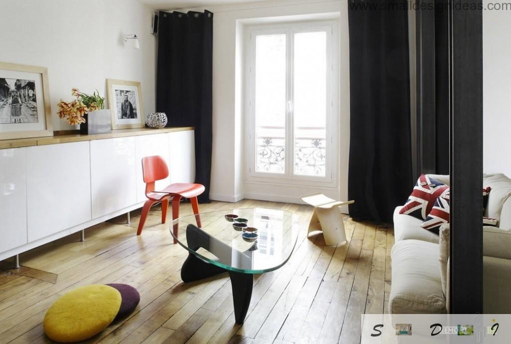 Red chair as the contrast to the wooden theme of the living room floor