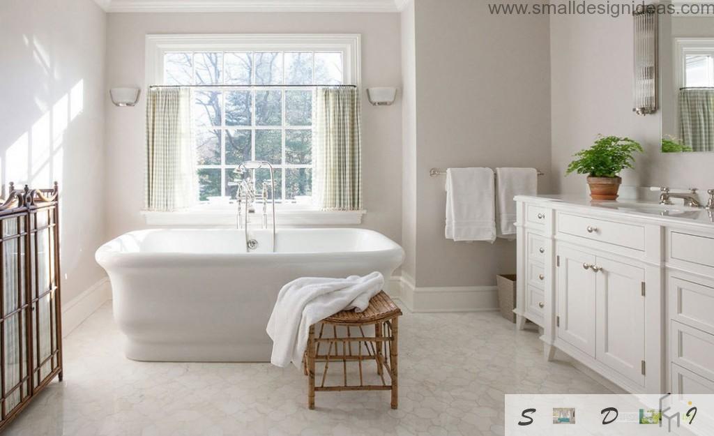 Wooden chair and a plant brings naturality in the white bathroom interior