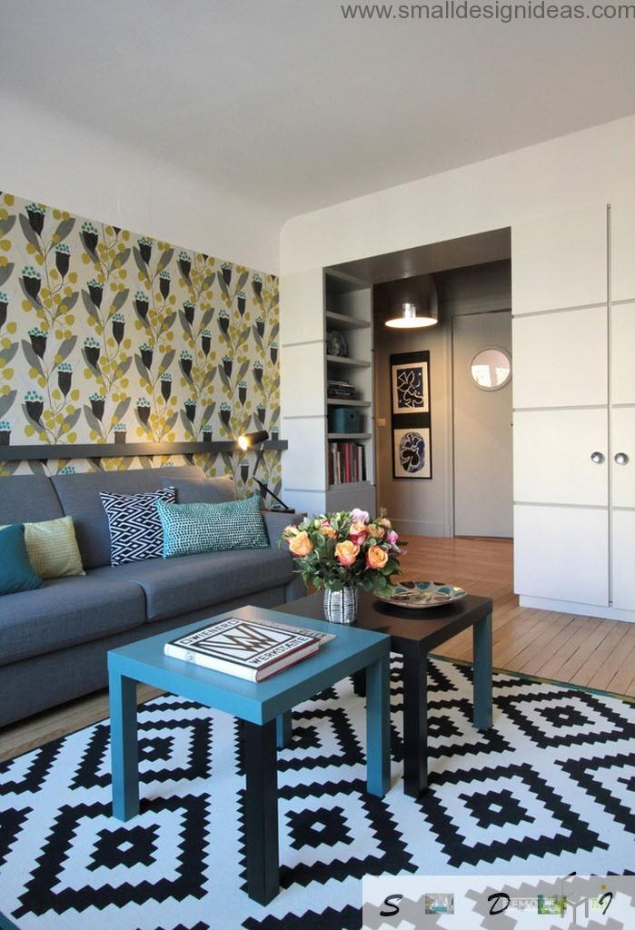 Nice cozy interior of the living room with combined wallpaper wall trimming and black and white carpet