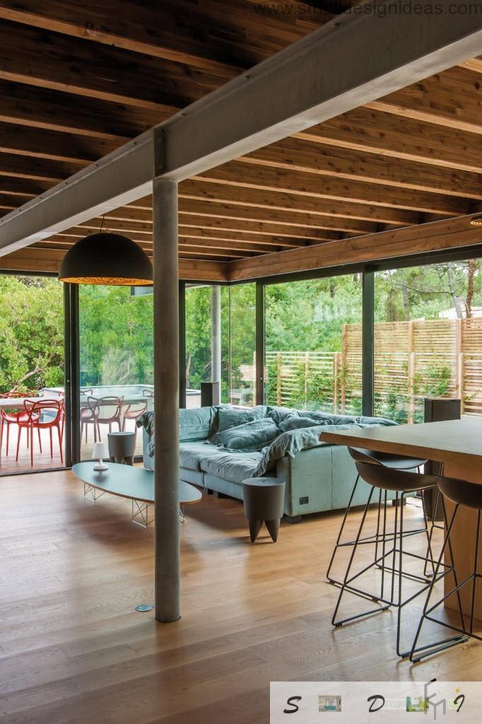 Outside wooden terrace also can transform into cozy living room thanks to modern furniture and a bar