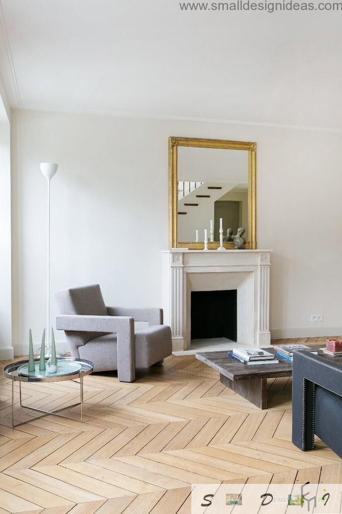 Mirror and fireplace near the armchair in contemporary design of the livin room