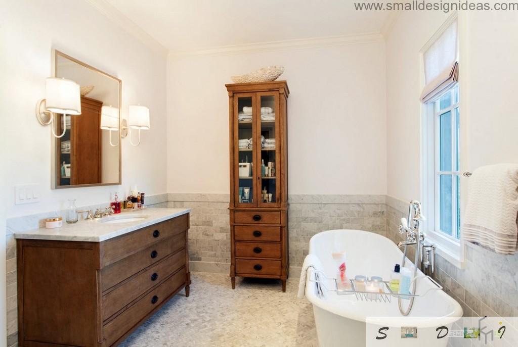 High wooden cabinet in the interior of classic white bathroom with tile finishing of the low side