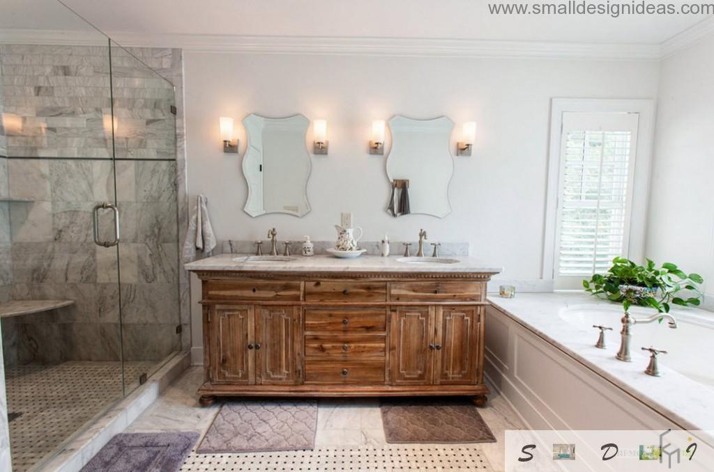 Unique wooden chest of drawers in the classic white bathroom interior with two sinks and mirror surface of the shower cubicle