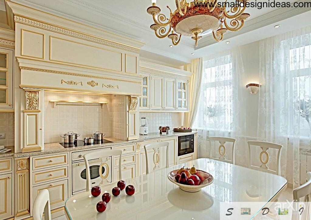 Enpire kitchen in all white with golden inlays and chic chandelier of medieval design. Wide windows finishing the image of luxury