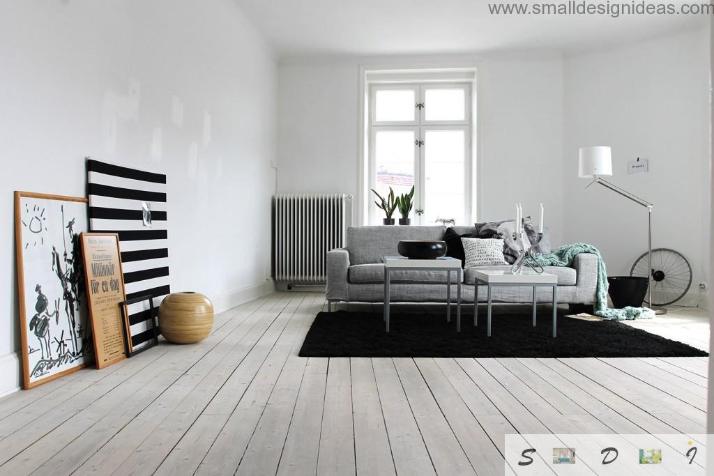 Austere scandinavian design in th white and black tones for the living room with wooden floor