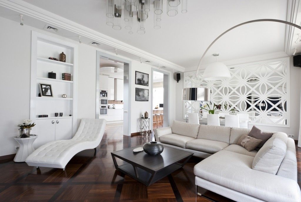 White Art Deco relaxing zone within spacious living room with dark floor and coffee table