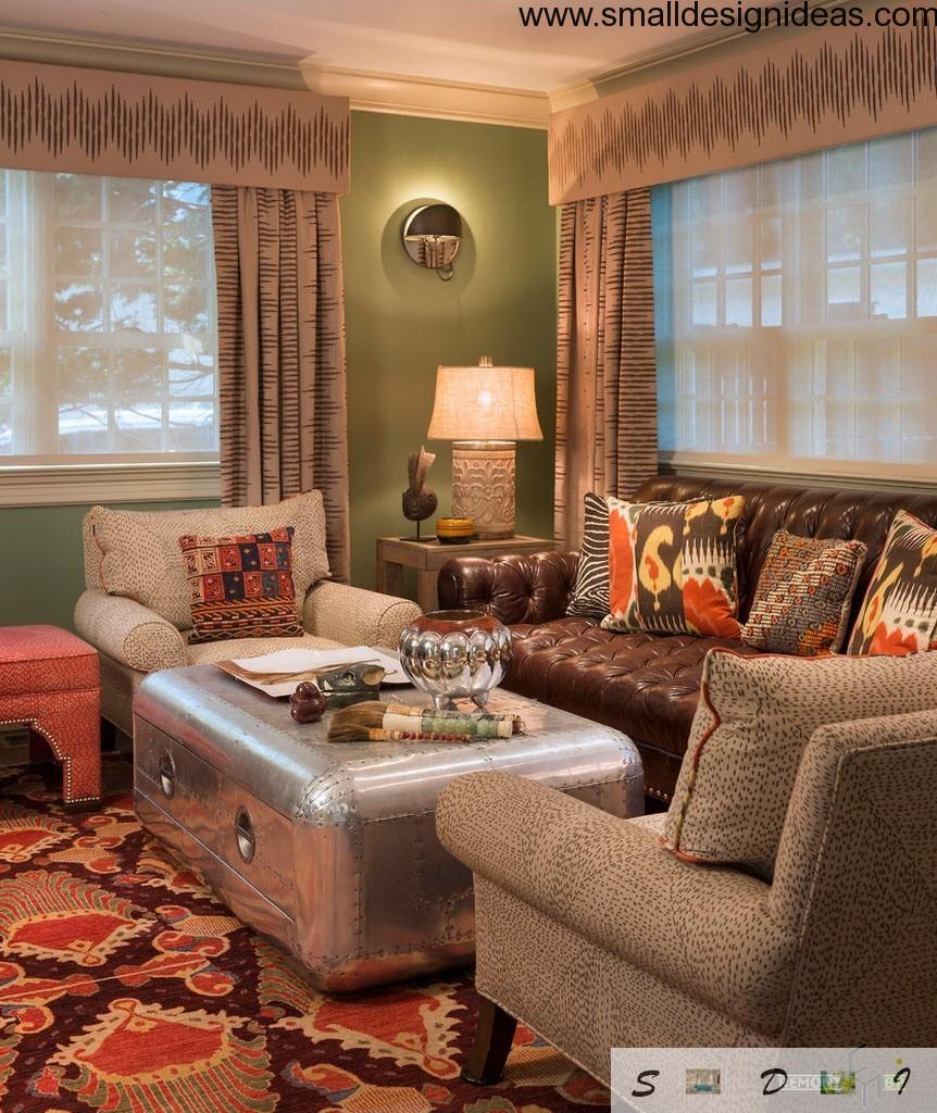 Unusual metall table in the centre of the eclectic living room with carpet and green walls