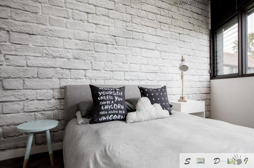 White brickwork in the white bedroom with original black cushions