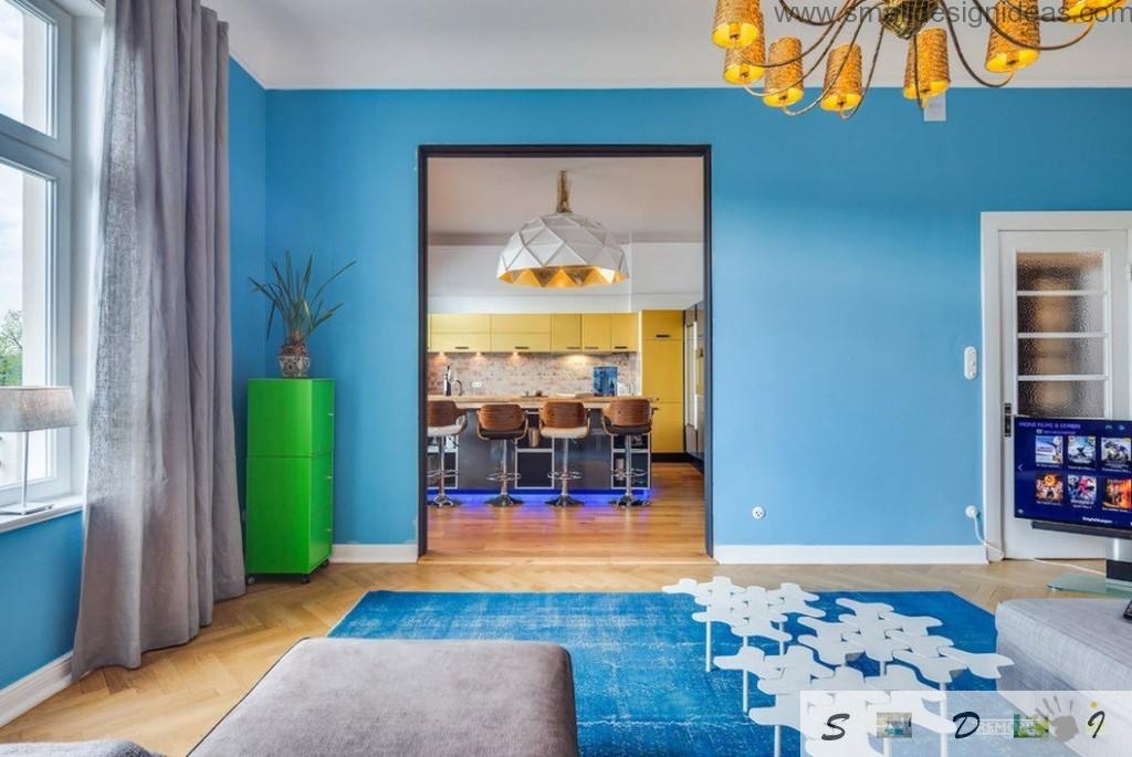 Prospective to the loft German apartment kitchen through the entrance with navy blue walls