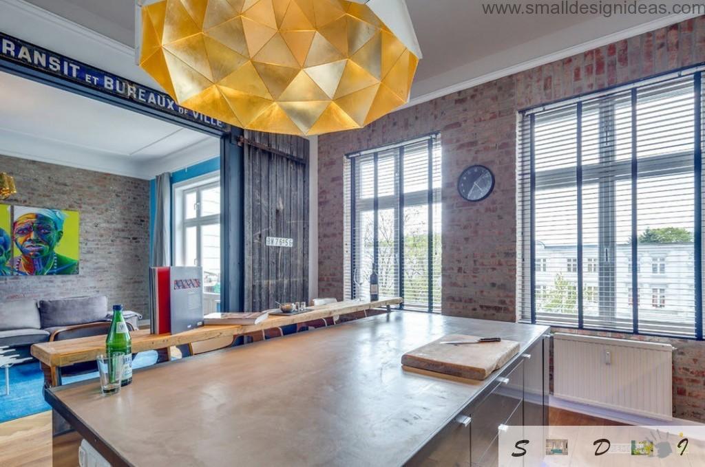 Island form of the kitchen set and brickwork as the decoration idea in the loft German apartment