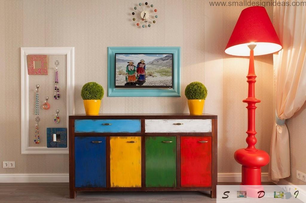 Colorful chest of drawers in the modern bedroom interior with red lamp