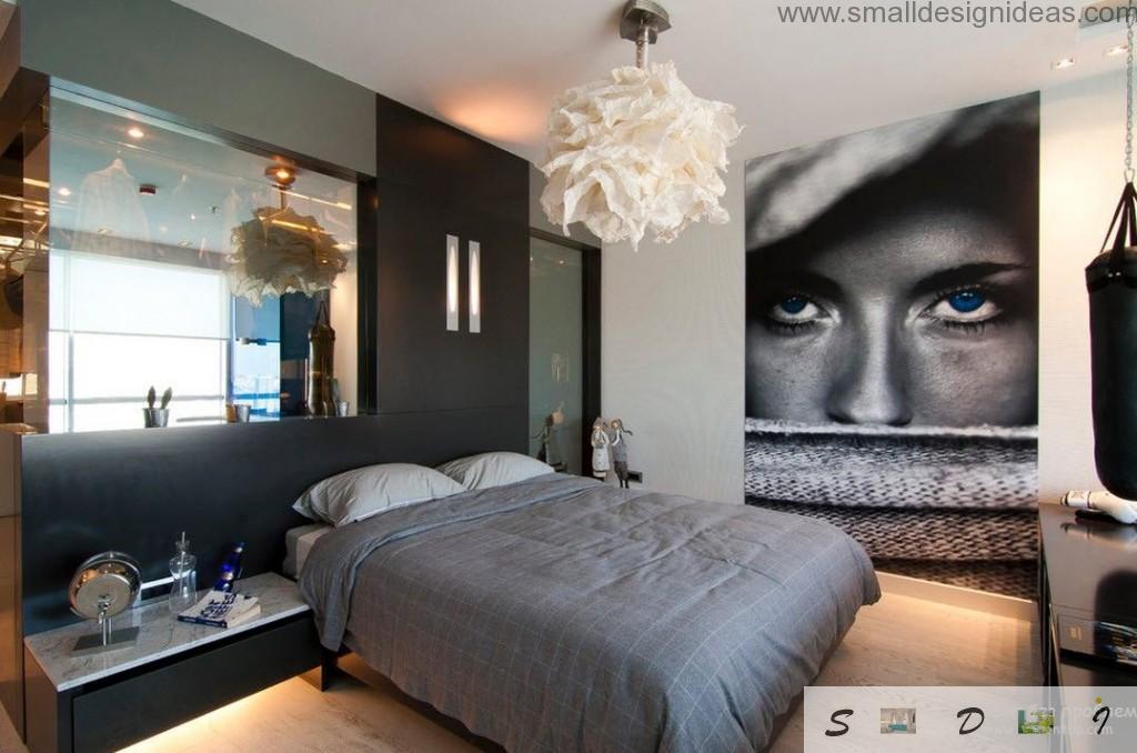 Unusual men`s room design with huge poster, mirror at the wall and tule lamp