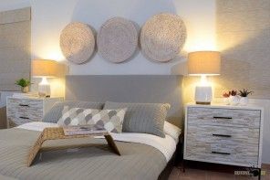 Alternative method to decorate the bedroom with textile round rolld above the headboard