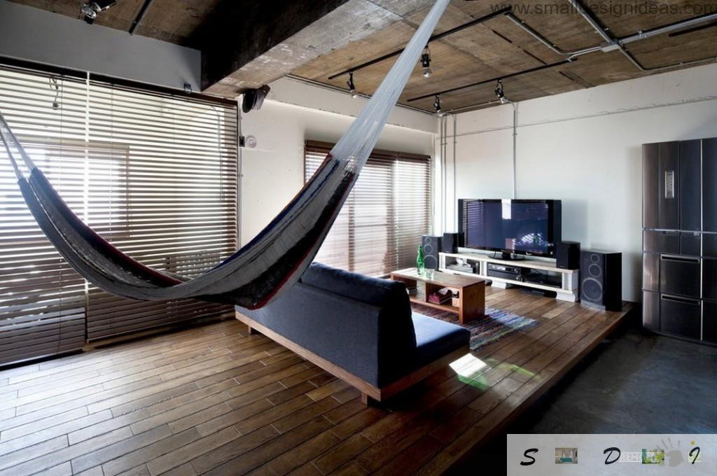 Hammock and sofa before the bed is a nice design idea for modern apartments