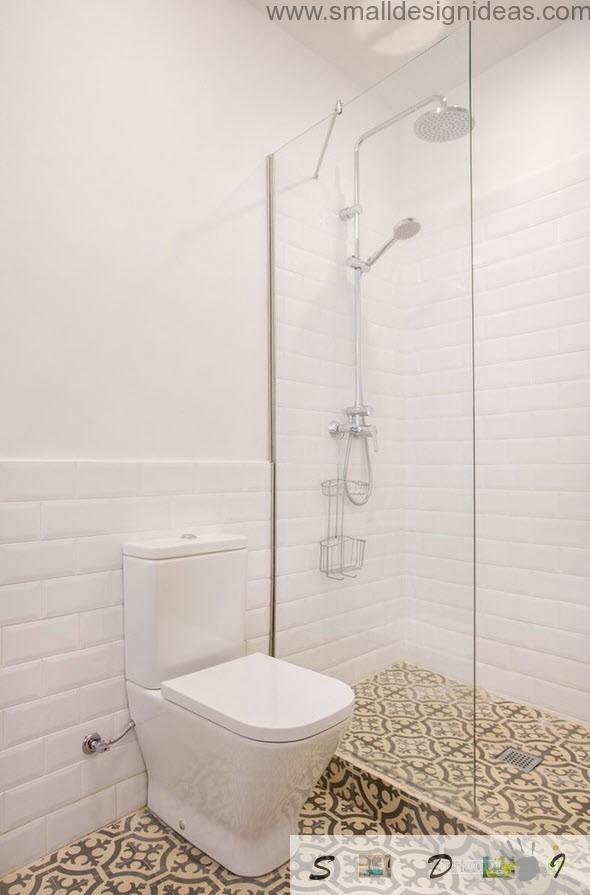 WC dari aparmtent studio berwarna putih dan biasa dengan ubin lantai gaya yang sama