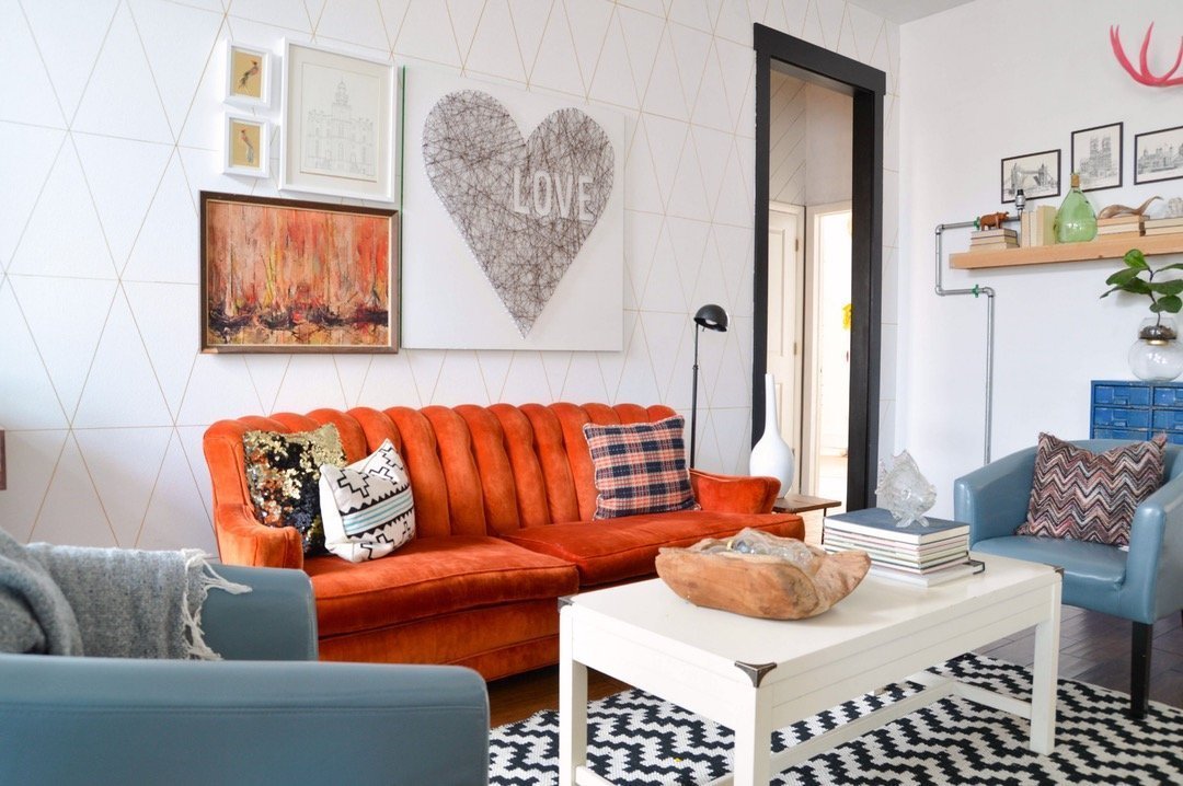 Nice and simple decorated living room with catchy orange sofa