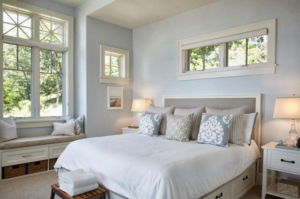 Bright womans bedroom with pale blue walls