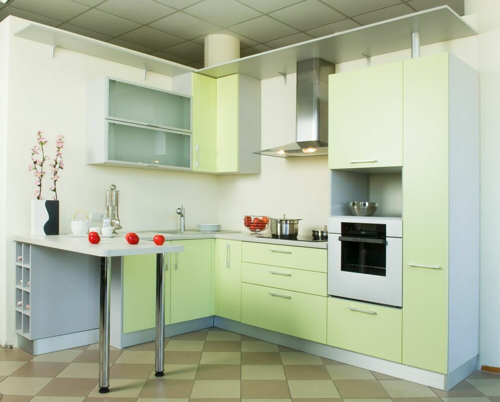 Modern Bar Counter Kitchen Design Ideas. Soothing light green surfaces of the kitchen furniture