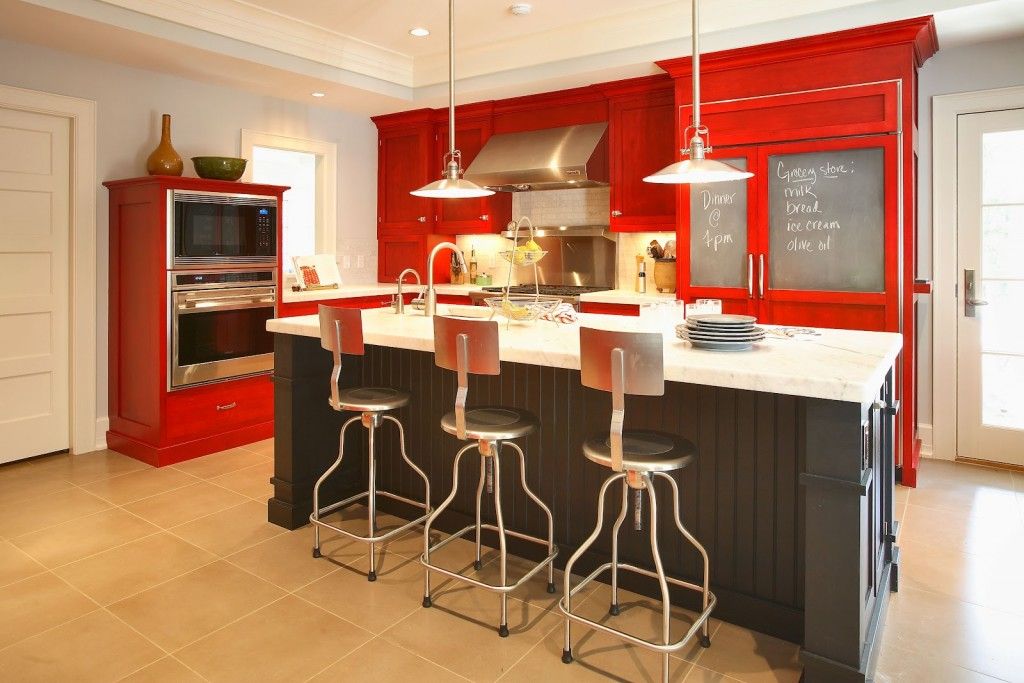 Red Color Interior Design Ideas. High bar stools and red surfaces of the kitchen set makes the interior fresh and lushy