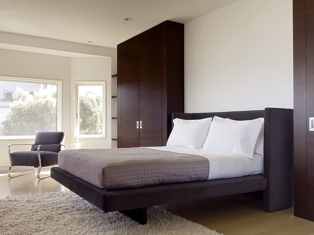 Bedroom Interior Furniture Set Programme Ideas. Black high wooden cabinet in the predominantly white bedroom interior