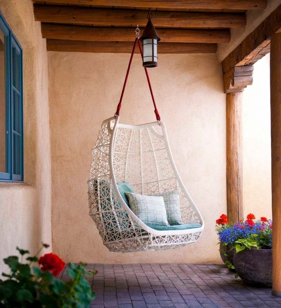 Mediterranean Interior Design Style. Swing chair on the red rope in the creamy wall surrounding