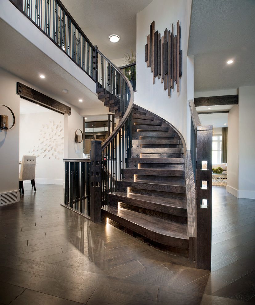 Modern Interior Staircase Materials Photo. Chic private house dark wooden interior in classic style with curved stairwell without risers