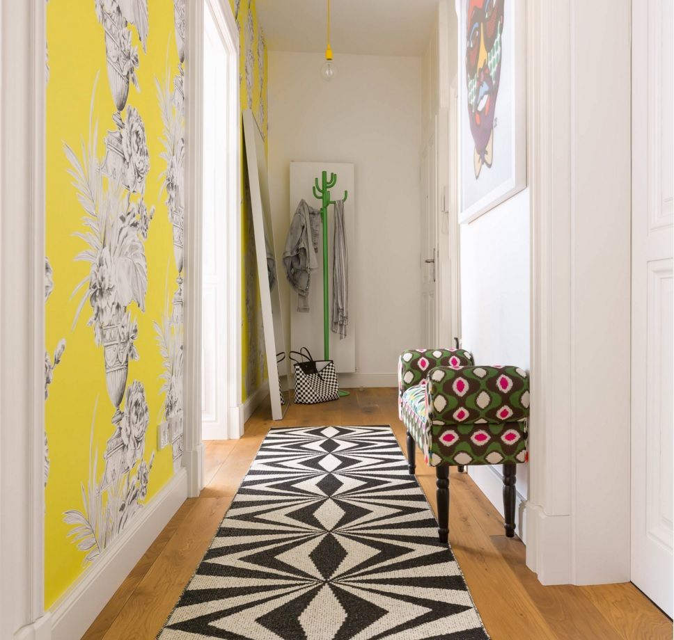 Yellow accent wall for the small apartment`s hallway