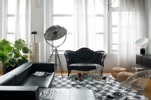 Black Furniture: Interior Design Photo Ideas. Corner sofa with unusual construction and the ottoman in front create the business image of the interior