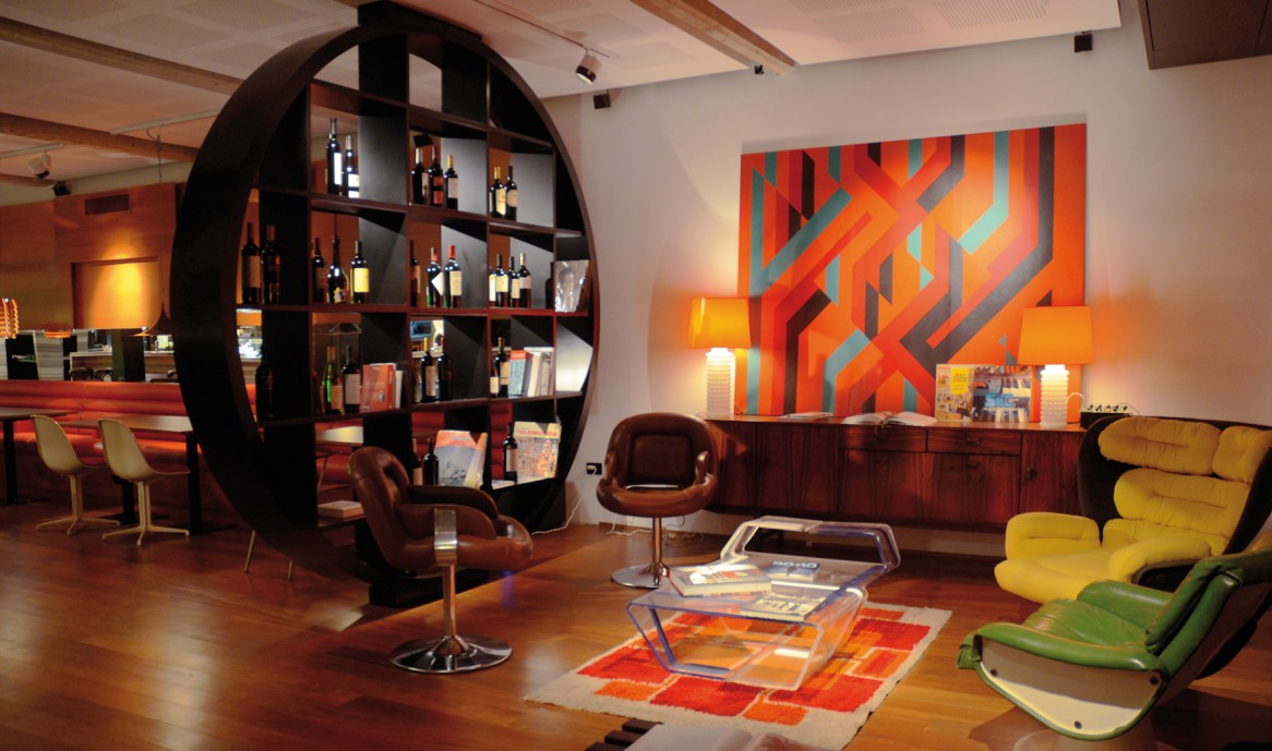 Kitsch Interior Design Style. Unusual round bookshelf made of wood