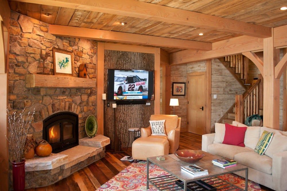 Top Ceiling Beams Design Photo Ideas. Stone and wooden trimming in the tight living room with the fireplace