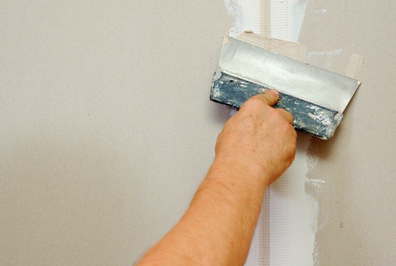 Putty Application on the plasterboard walls in the kitchen