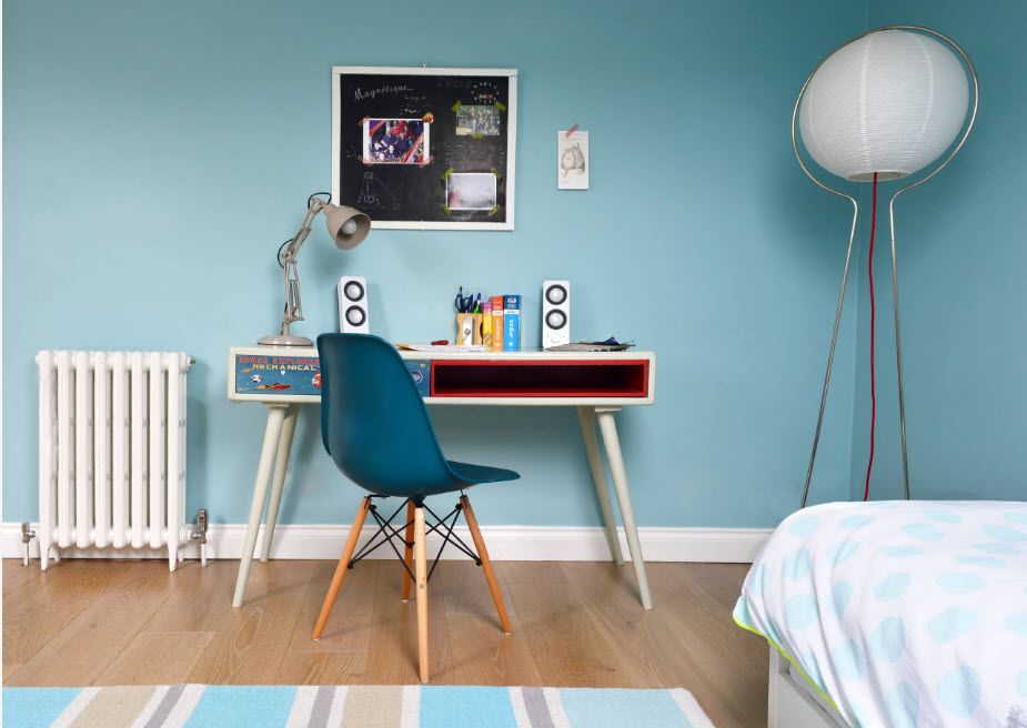 Creative interior design for the boys room with painted blue walls and furnished in modern style