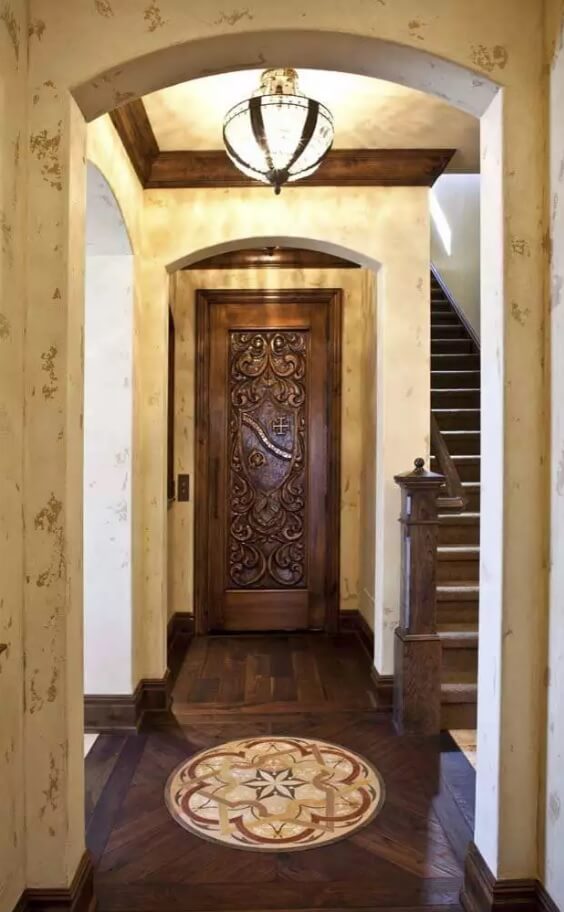 Carved Wooden Door as Piece of Art in your Interior. Noble classic interior with the stairs